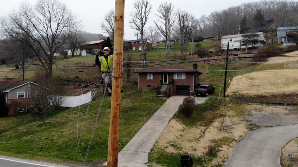 Gudenkauf lineman on pole in residential areas